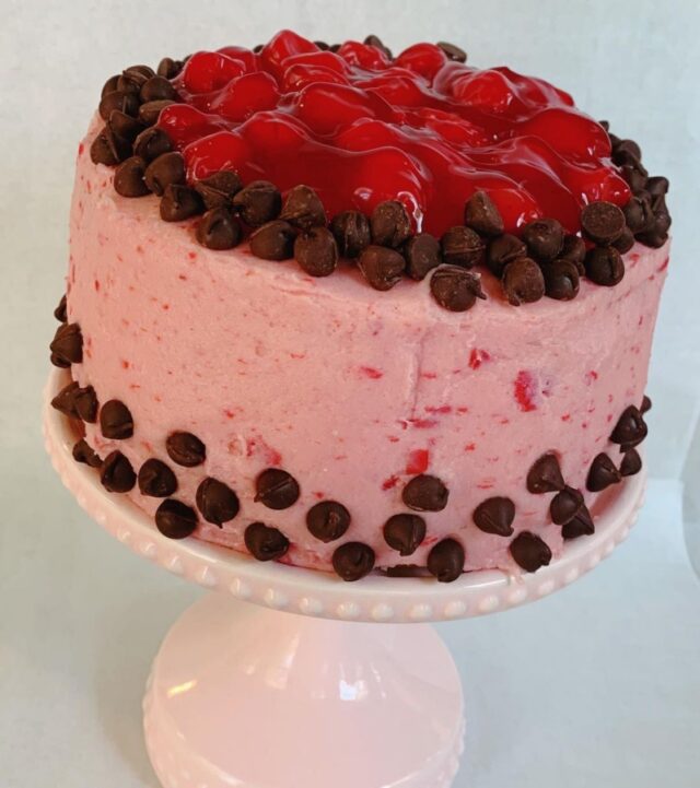 cake decorated with cherries and chocolate chips