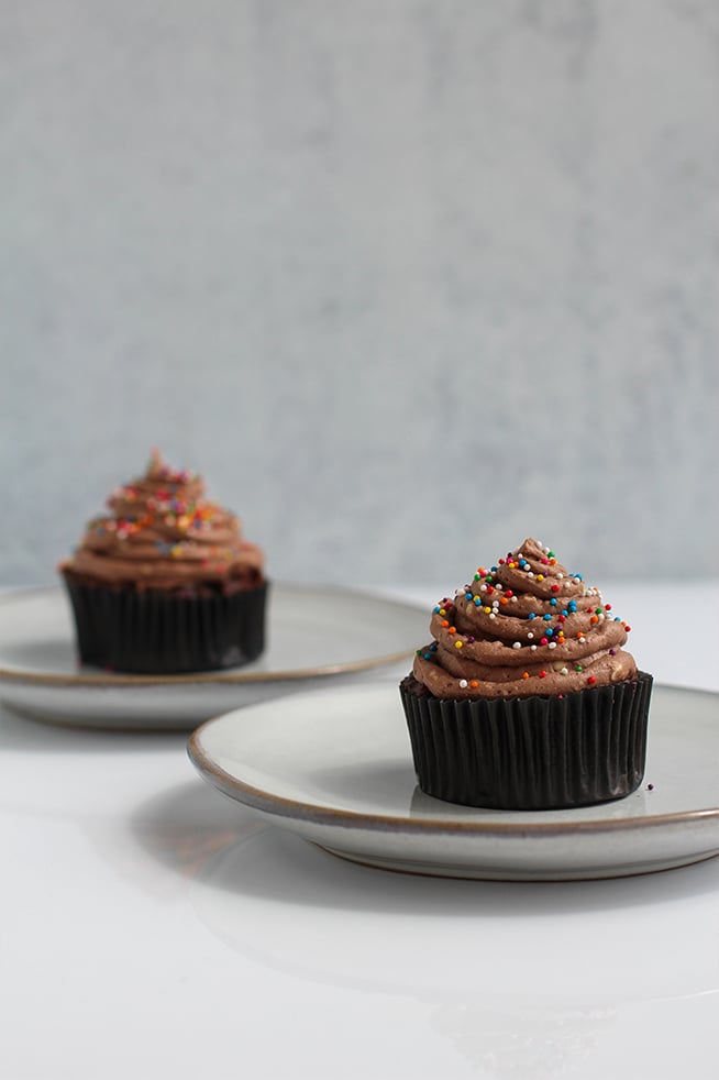 Chocolate Cupcakes with New Simply Delish Chocolate Frosting by @klean.kate close up showing 2 cupcake servings